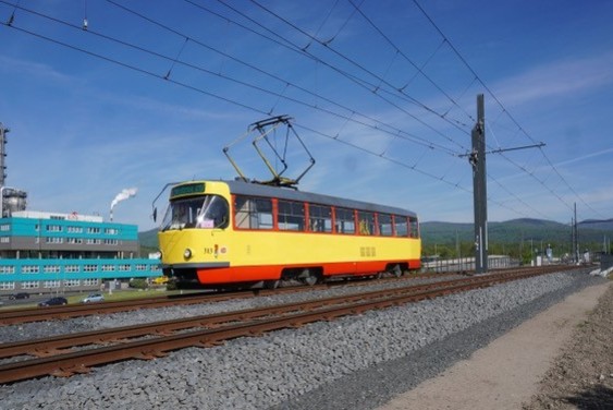 Vintage Tatra T3 313 (1987) runs through Záluží Petrochemie during a southbound trial run from Litvinov to Most on the interurban tramway, passing a newly-built bridge, with new tracks, ballast and overhead. (A. Thompson